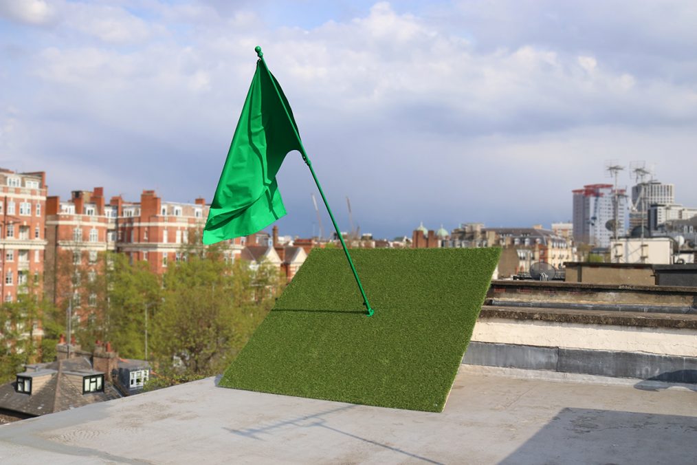 Allegory. Flag, flag pole, artificial grass, wooden structure 2021