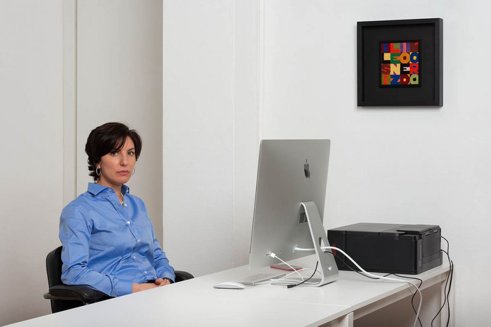 Tatiana Yasinek in the office with a work by Alighiero Boetti, photo by Mattia Mognetti